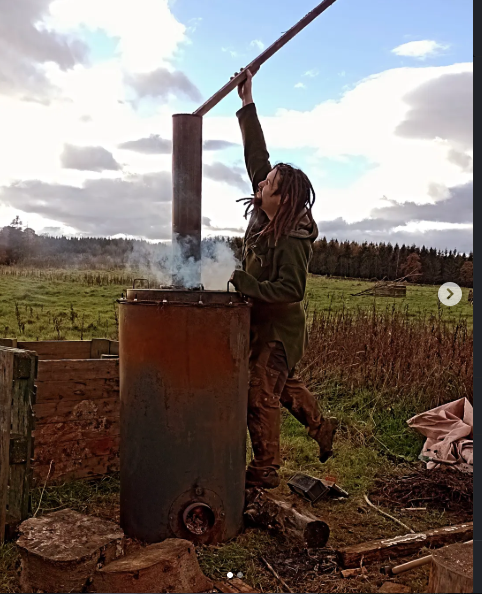 Andrew tending one of the barrel kilns outdoors